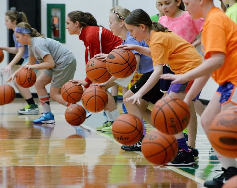 a group of girls playing basketball