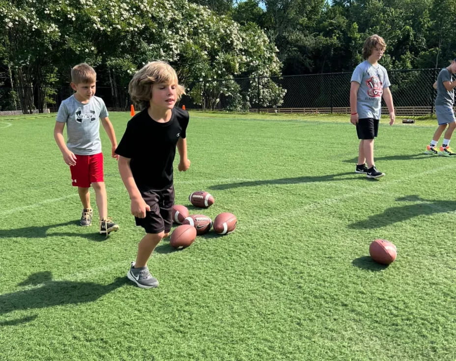 a group of kids playing with balls