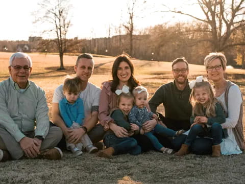 a group of people sitting together outside