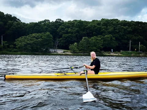 a man in a yellow kayak