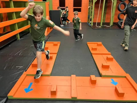 a boy jumping on a playground