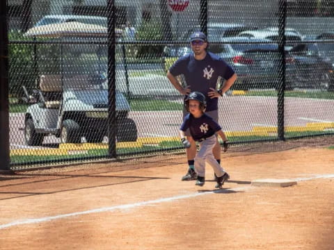 a man and a boy playing baseball