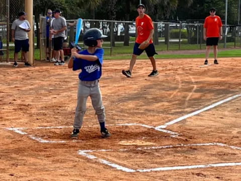 a kid holding a baseball bat