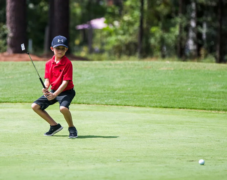 a boy playing golf