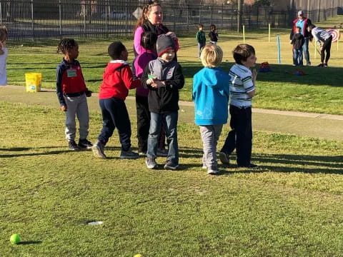 a group of children playing in a field