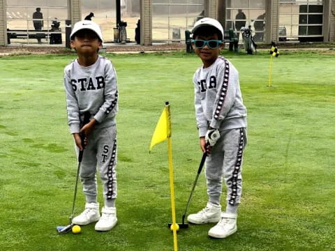 a group of kids playing golf