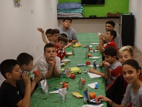 a group of children sitting around a table