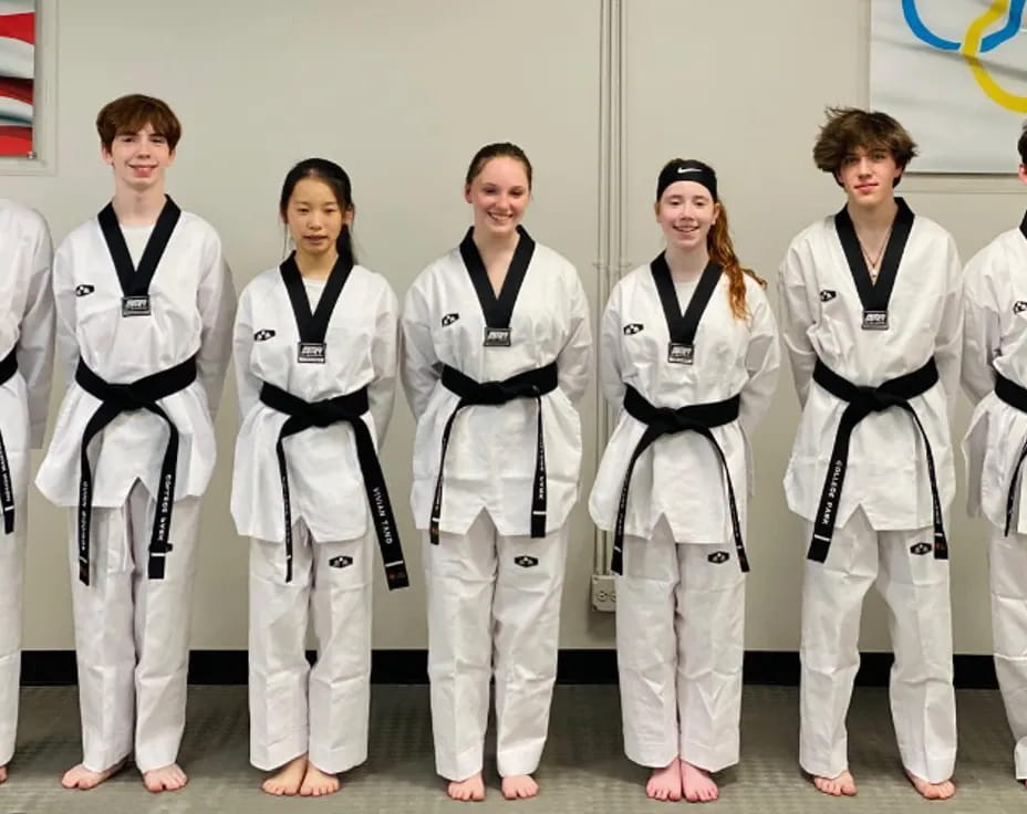 a group of people in karate uniforms