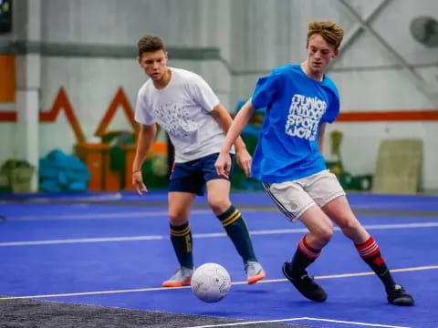 a couple of men playing football