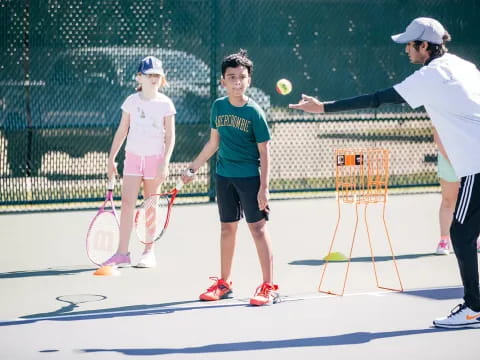 a group of people play tennis