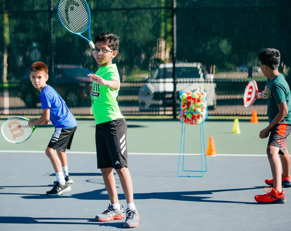 kids playing tennis on a court