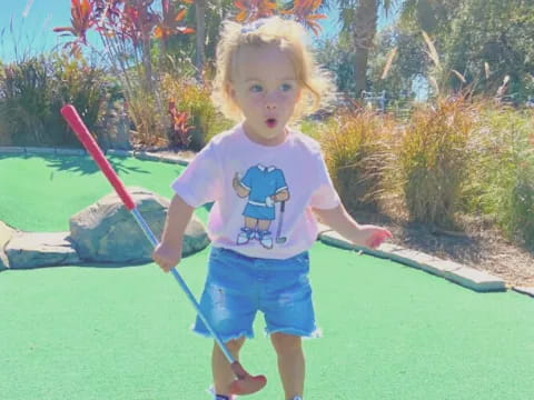 a child holding a toy sword