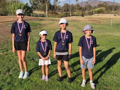 a group of people wearing medals