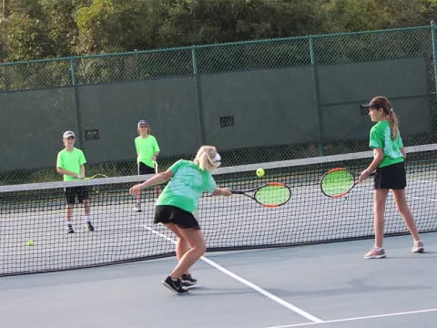 a group of people play tennis