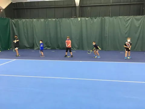 a group of people play tennis