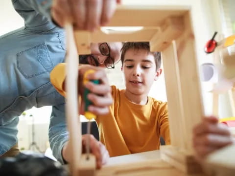 a person and a boy playing with toys