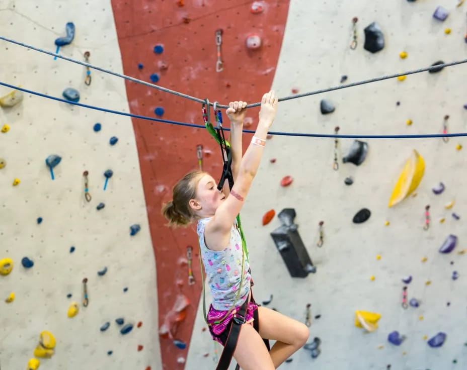 a girl climbing a rock wall