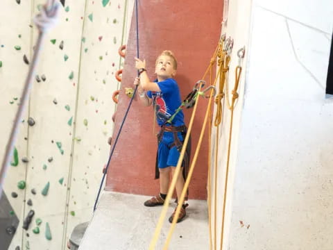 a young boy climbing a wall