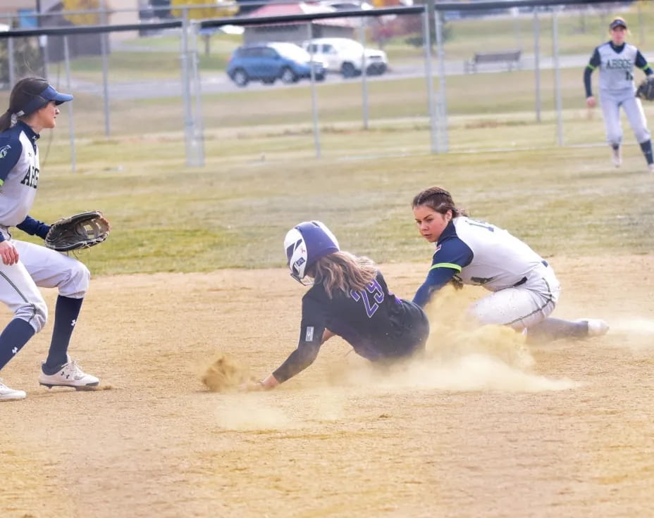a person sliding into a base