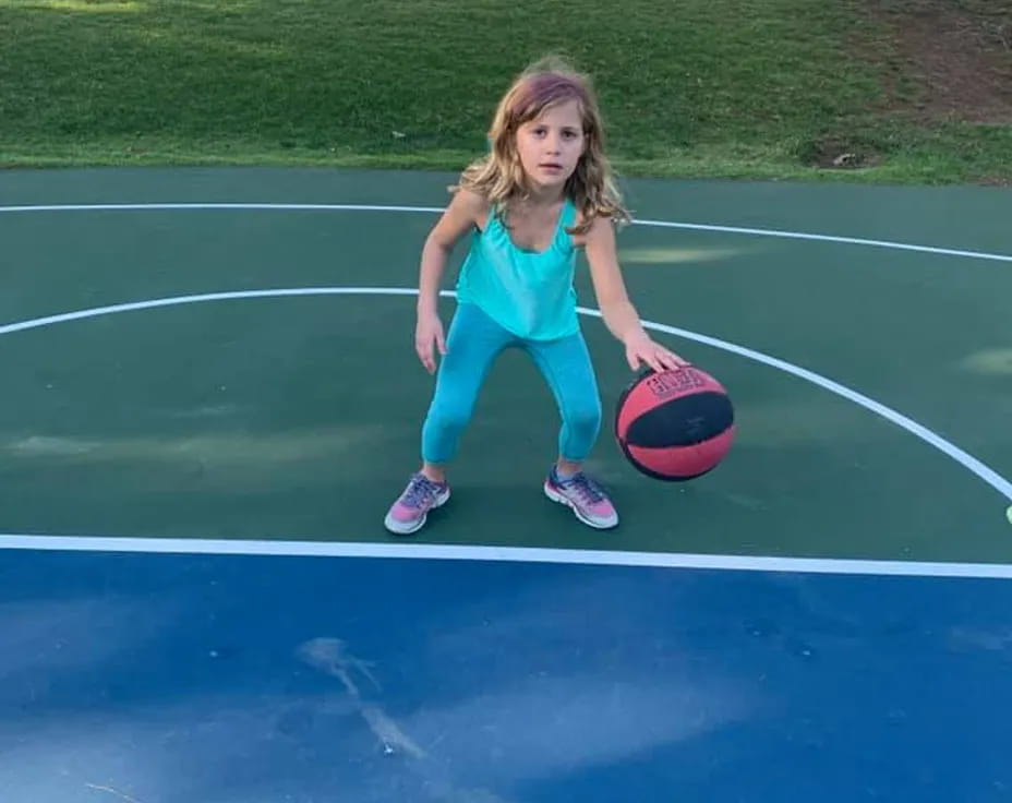 a girl holding a ball