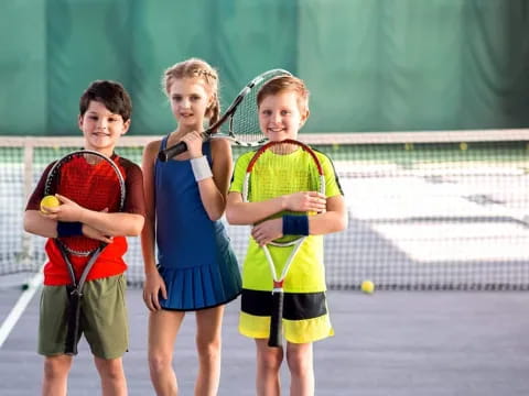 kids holding tennis rackets