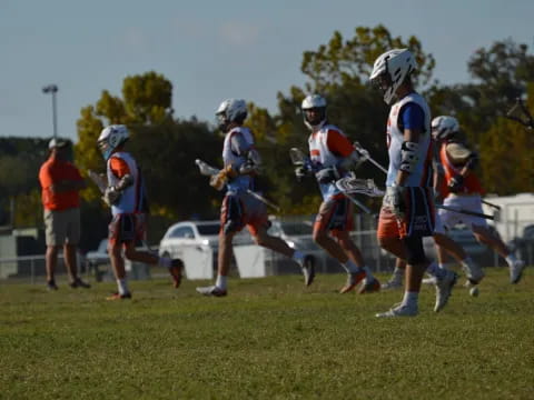 a group of people playing lacrosse