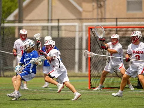 a group of people playing lacrosse