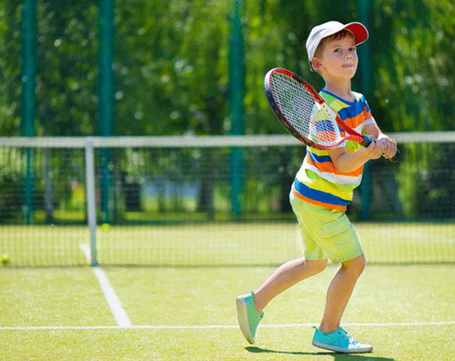 a boy playing tennis