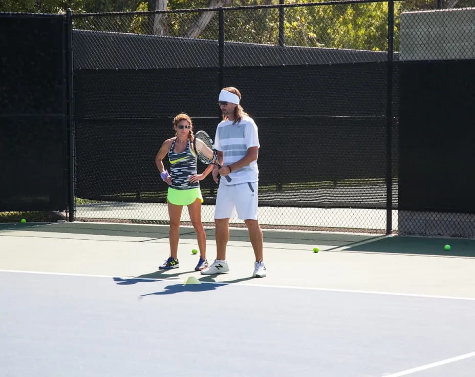 a couple of people play tennis