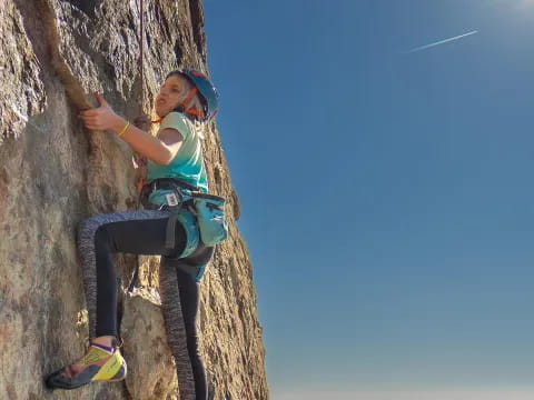 a man climbing a cliff