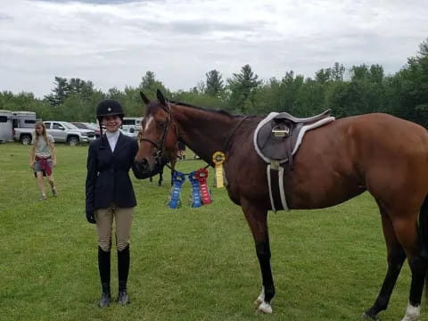 a person standing next to a horse