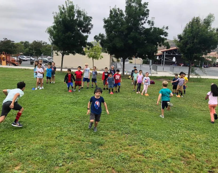 a group of kids playing in a field