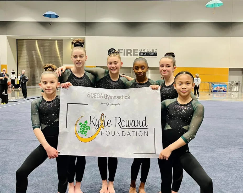 a group of women holding a sign
