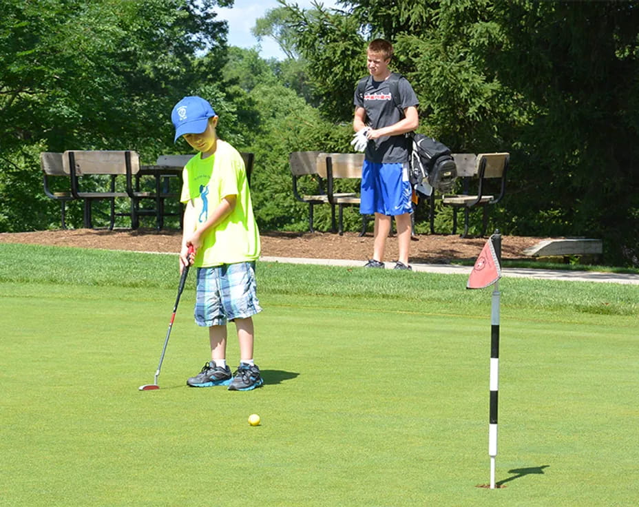 a boy playing golf