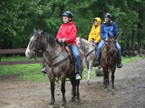a group of people ride horses