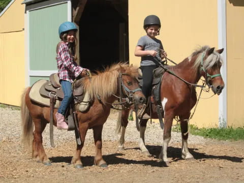 two people riding horses