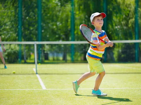 a boy playing tennis