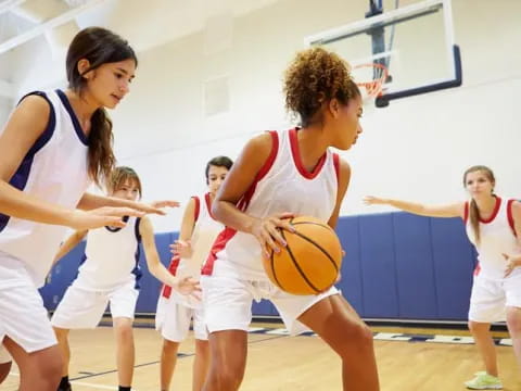 a group of women playing basketball