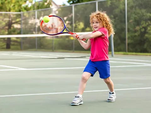 a girl playing tennis