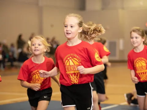 a group of girls in red shirts