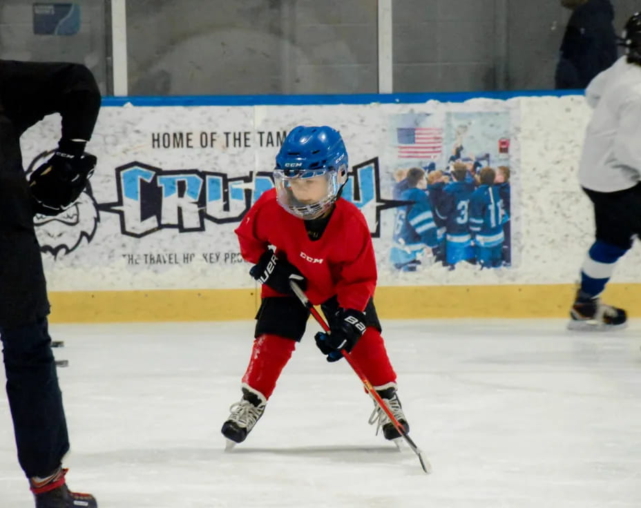 a young boy playing hockey
