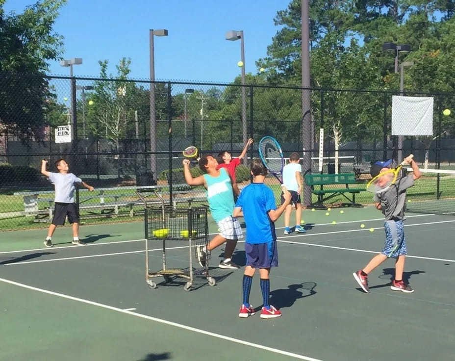 kids playing tennis on a court