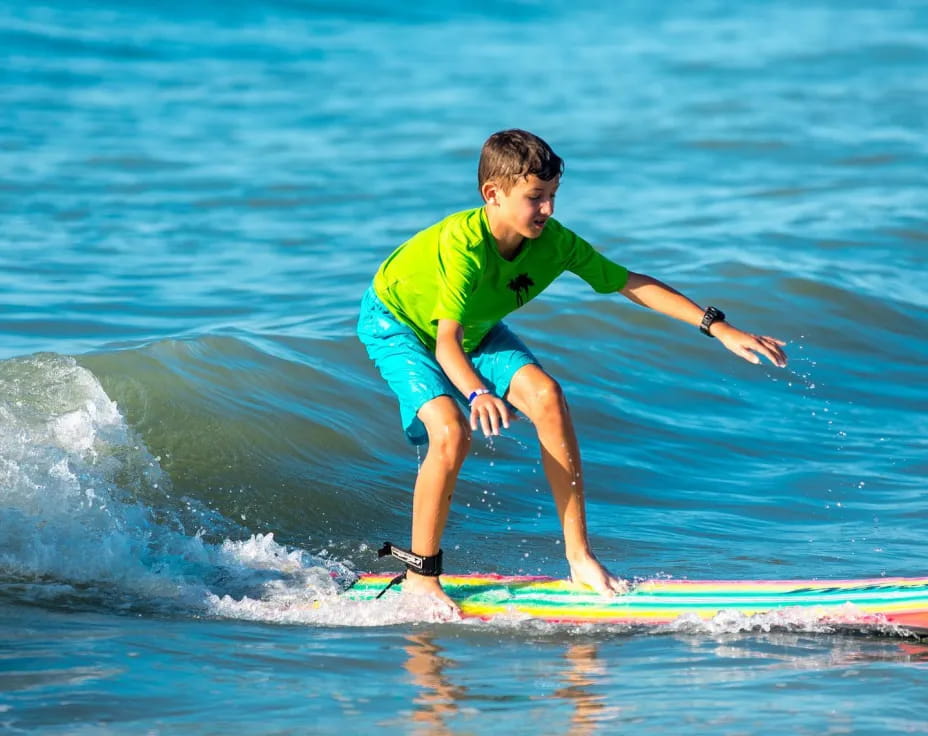 a boy surfing on the waves