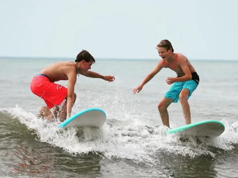 a couple of men surfing in the sea