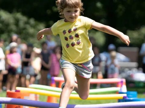 a child jumping over a bar