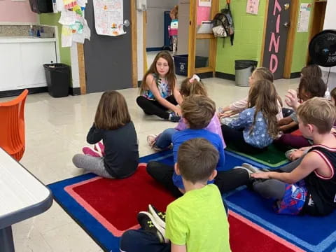 a group of children sitting on the floor