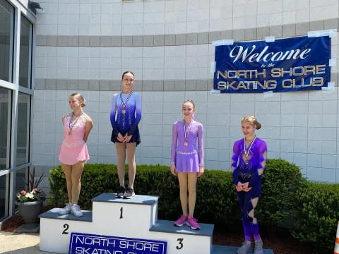 a group of women in purple uniforms standing on a podium