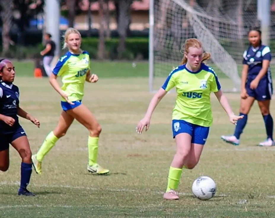 girls playing football on a field