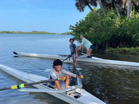 a group of people rowing a boat