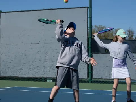 a man and a woman playing tennis